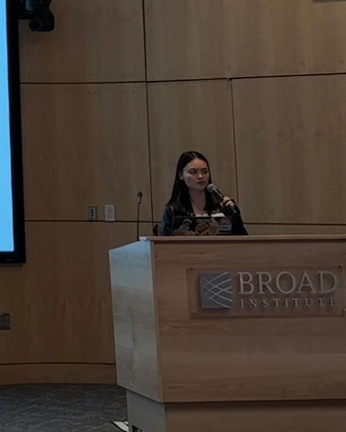 A BALSA speaker presenting from the podium at the Broad Institute