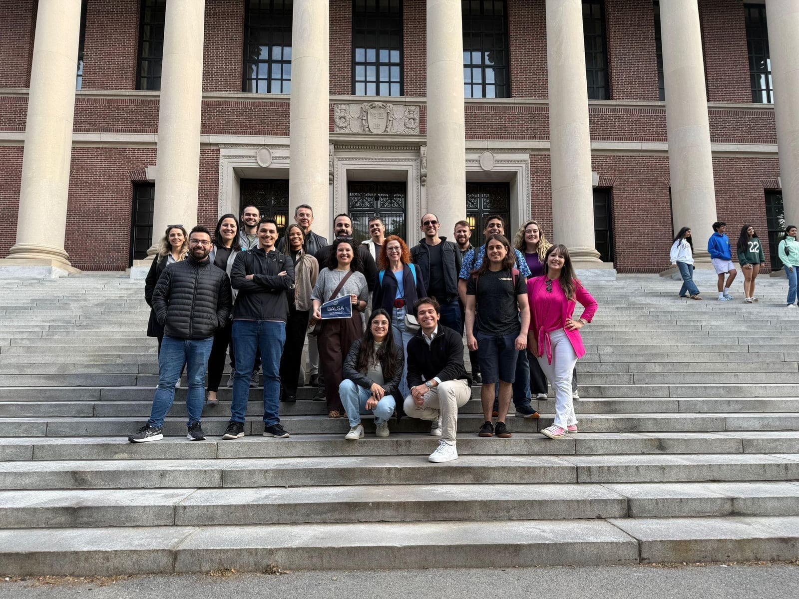 Members on the steps of Widener Library holding a BALSA sign