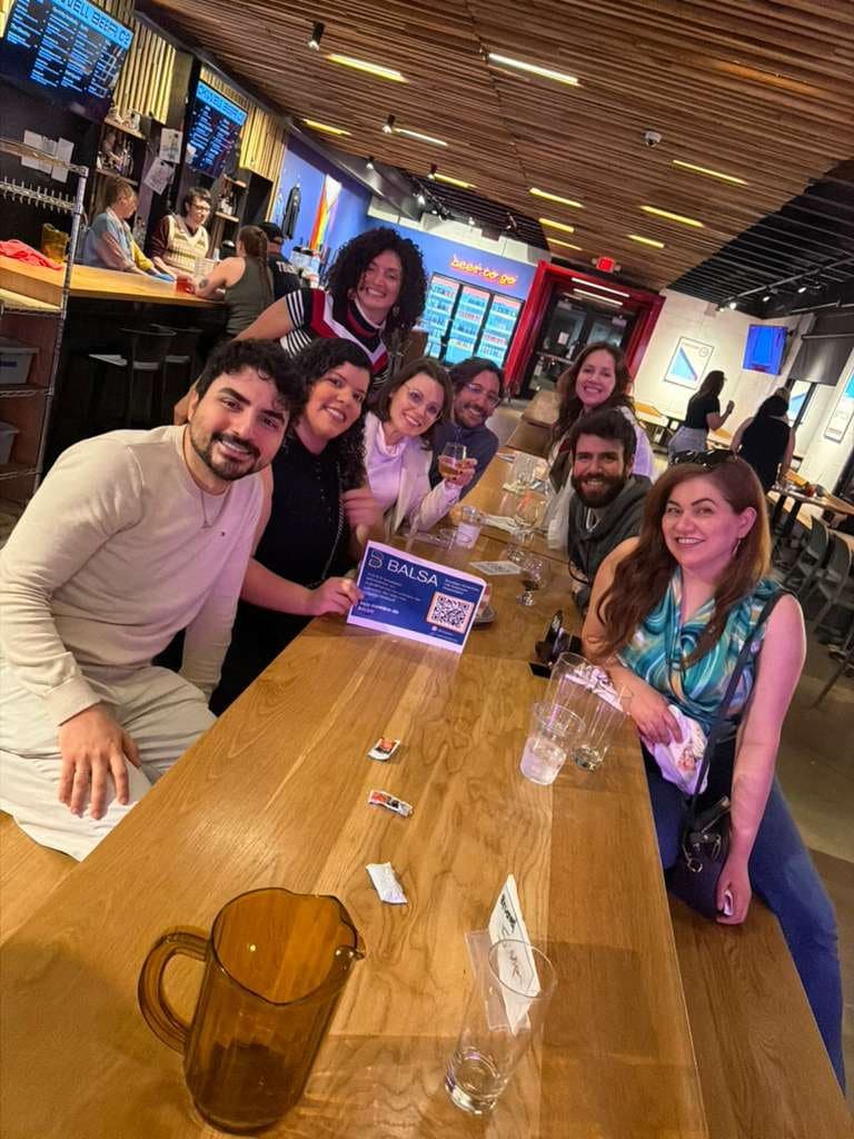 Members around a table at a brewery meetup